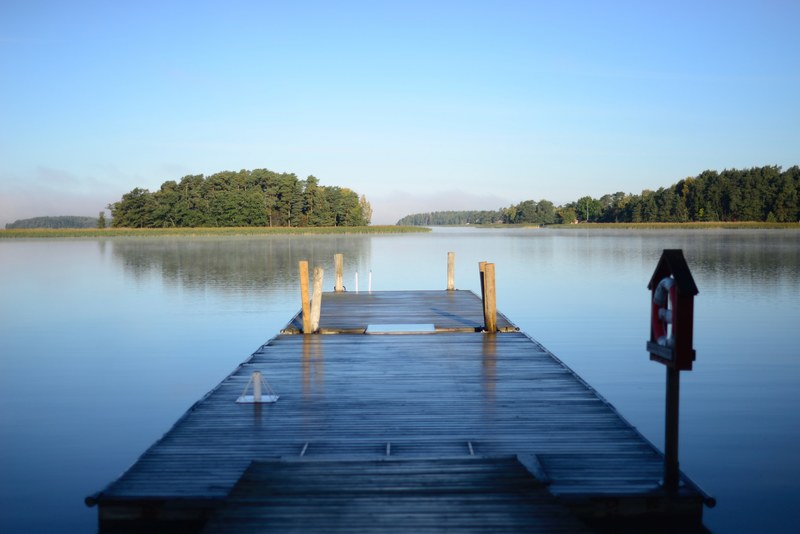 a small wooden pier on a lake in naantali, small lake pier 4k