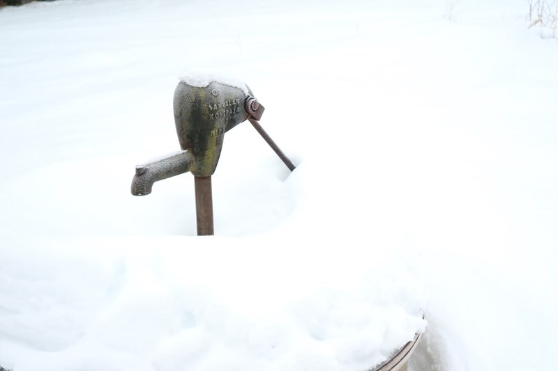 old pump buried in snow 4k