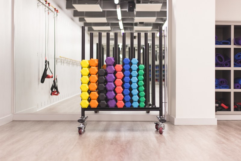 colorful weights in an empty home gym, fitness trello 4k
