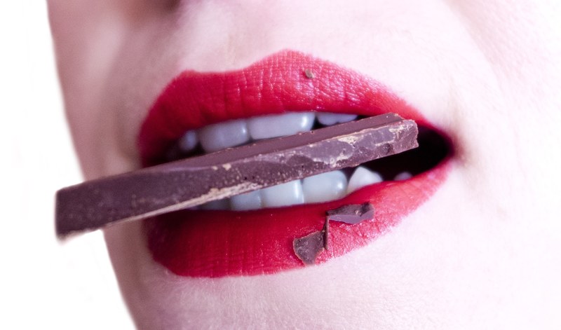 woman mouth teeth sweets chocolate bite 4k