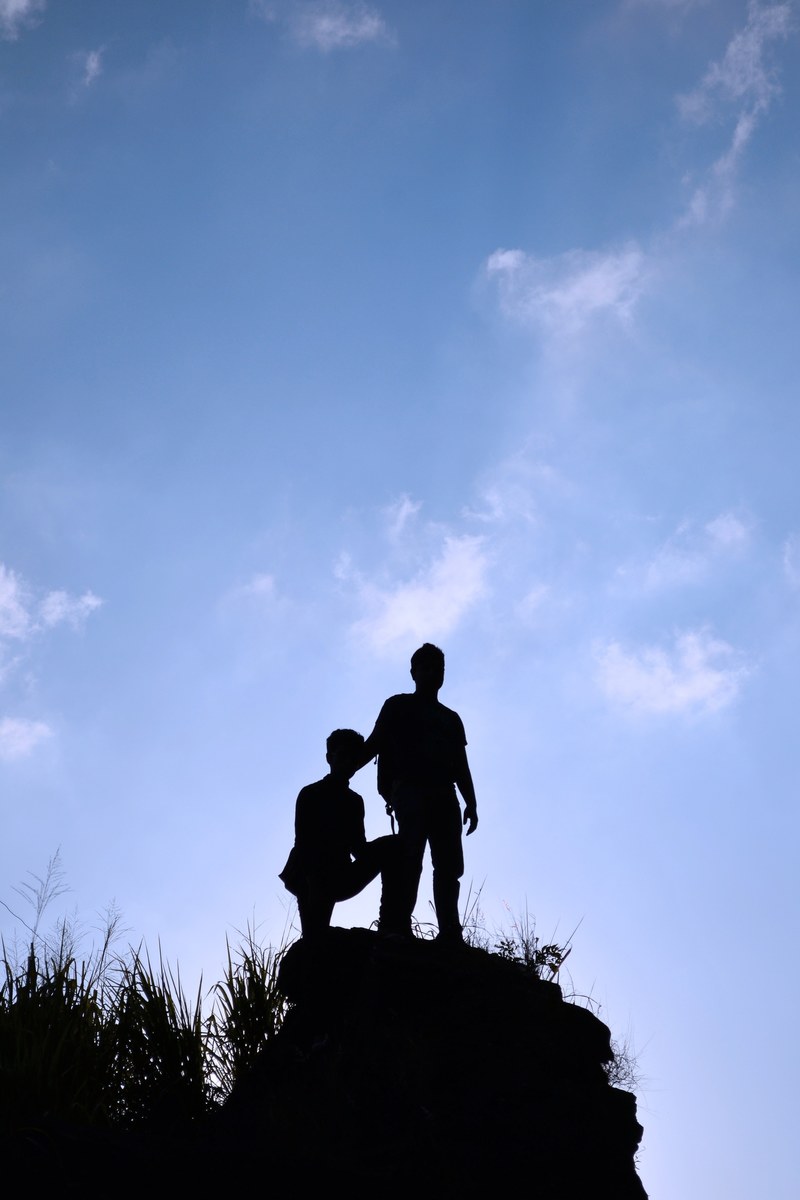 silhouette boys sky tall rock people blue sky 4k