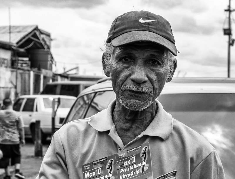 man selling razors black and white older outside 4k