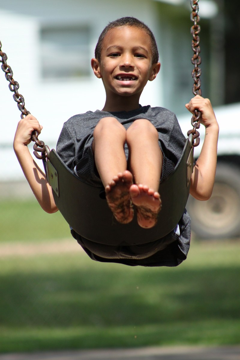 kid boy swinging young swing outside summer 4k