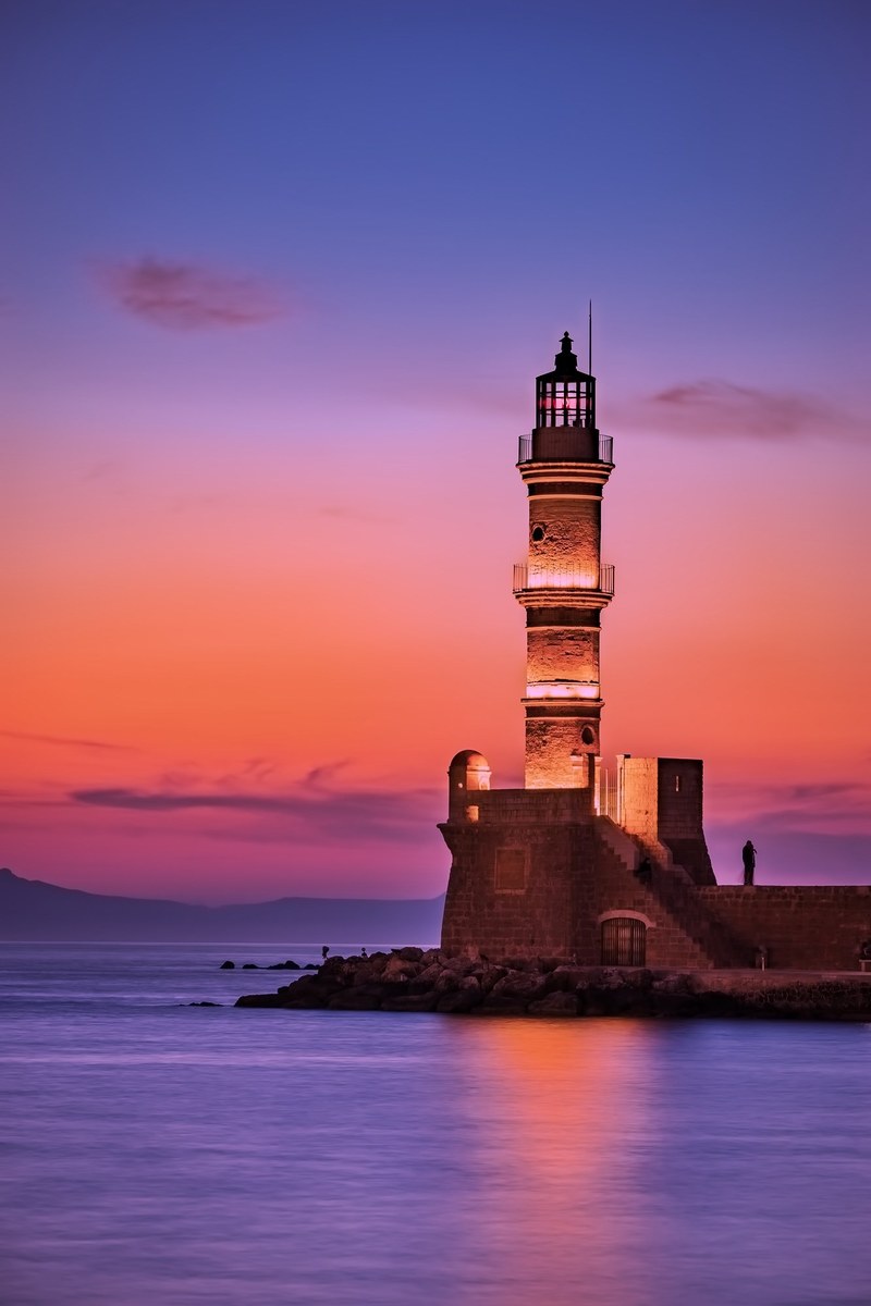 greece lighthouse jetty quay sea ocean reflection 4k