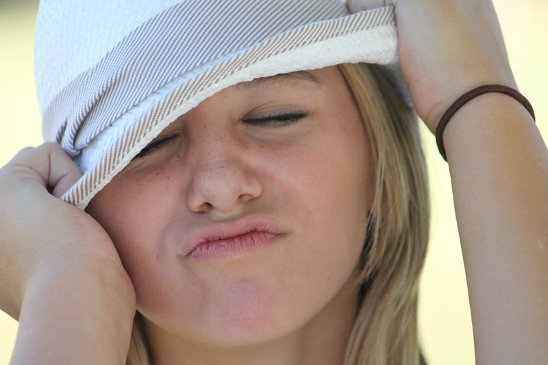 girl face portrait hat close up making a face 4k