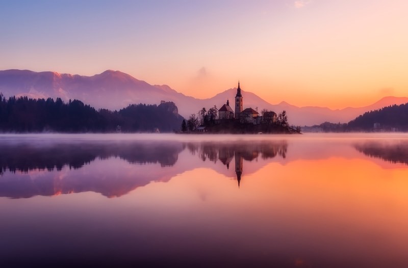 bled slovenia sunrise morning fog haze mist lake 4k