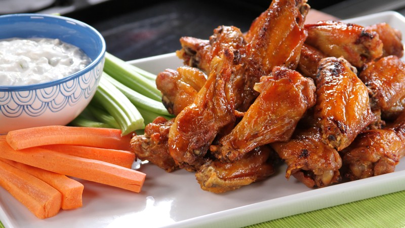 Buffalo wings, sauce, vegetables, carrots