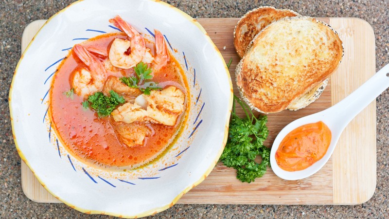 seafood soup, shrimp, tomato sauce, greens, croutons