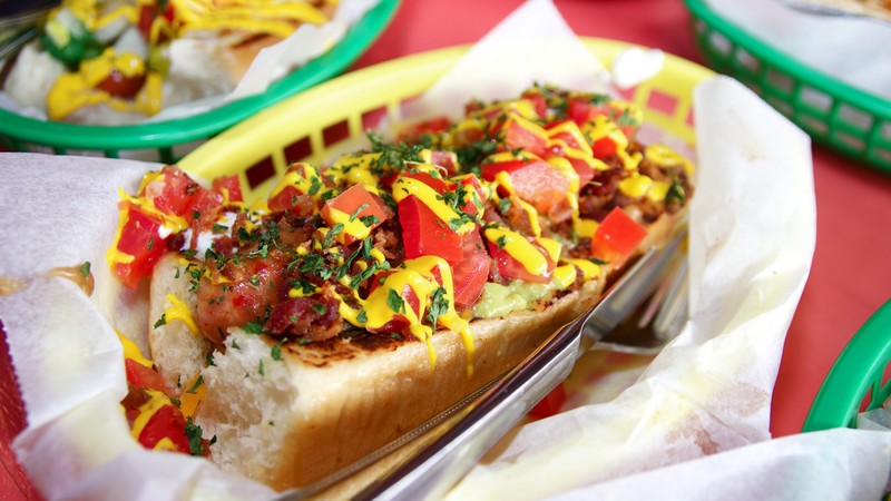 dat dog, hot dog, ketchup, mustard, lettuce, tomatoes, peppers, cucumbers