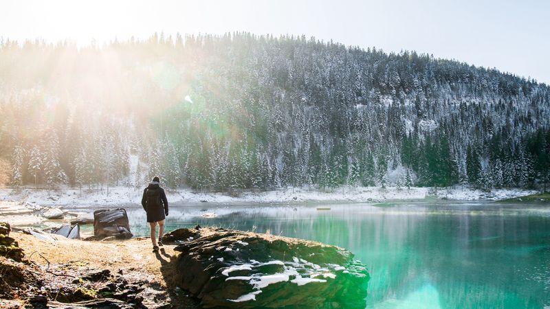 man, rocks, mountains, lake, sunlight, nature, 4k