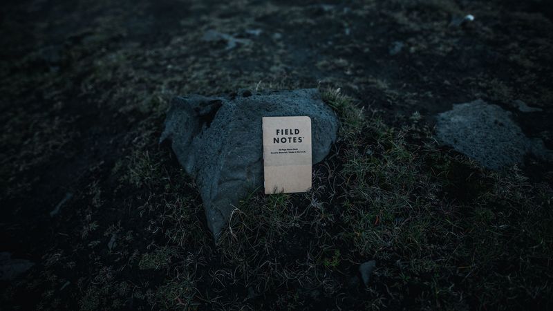 stone, notepad, inscription, grass, ground, 4k