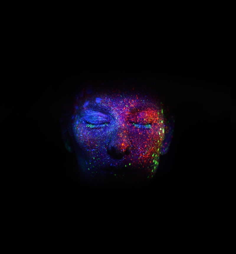creativity, human face, ultraviolet, body paint, 5K, vibrant color, copy space, black background, dark, face, blue, s, studio shot, hairstyle, adult, multi colored