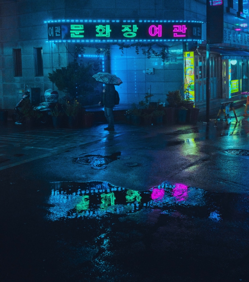architecture, cyberpunk, one person, real people, road, building exterior, transportation, reflect, midnight, built structure, blue, puddle, leisure activity