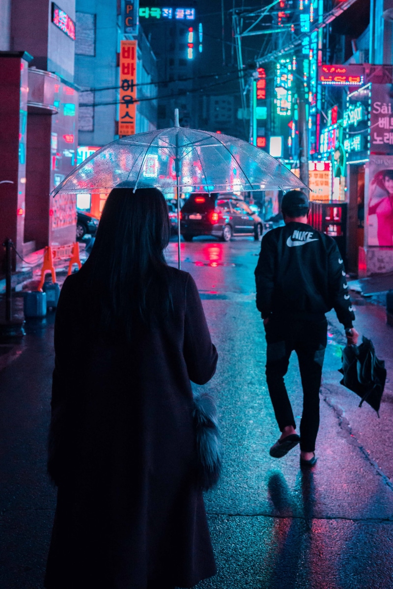 built structure, city, warm clothing, lights, lifestyles, anonymous, illuminated, outdoors, architecture, gray, person, transportation, leisure activity