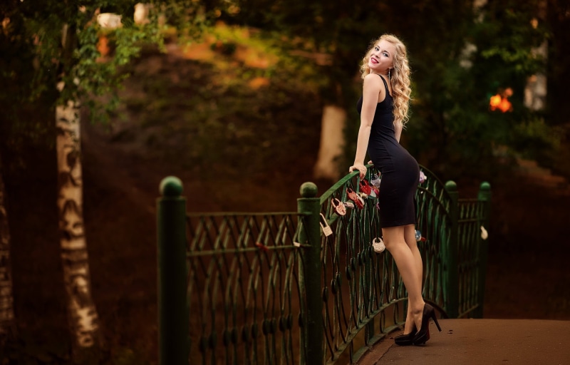 outdoors, fashion, looking at viewer, long hair, railing, young women, one person, full length, dress, arched back, beautiful woman, women, legs, adult