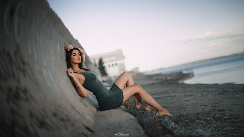tight clothing, nature, full length, sitting, strap, real people, rock, tight dress, beauty, spaghetti, beautiful woman, sky, portrait, leisure activity