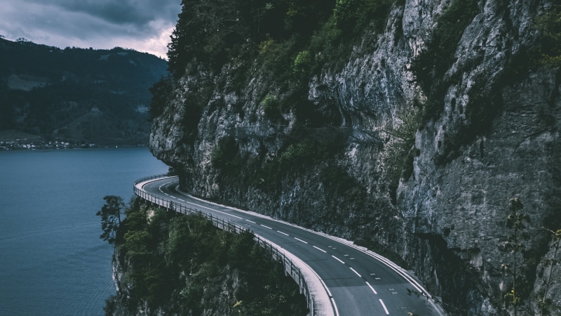 motion, water, asphalt, transportation, sky, curve, landscape, Switzerland, pave, travel, street, rock - Object, lake, forest, hill, the way forward, sea