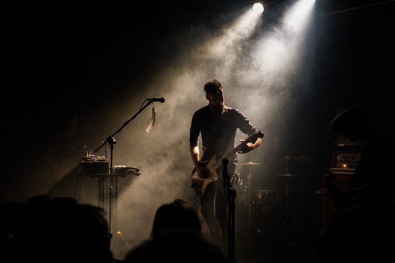 spot lights, dark, people, drums, illuminated, electric guitars, string instrument, musical instruments, artist, popular music concert, guitars, instruments