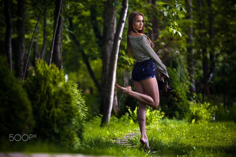 young adult, looking over shoulder, jean shorts, tree, top, women, real people, portrait, smiling, fashion, plant, forest, carefree, tanned, 720P, barefoot