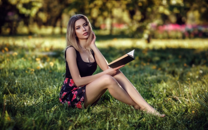 s, legs, leisure activity, beautiful woman, reading, barefoot, grass, pink, hair, women outdoors, fashion, minidress, land, contemplation, portrait, field