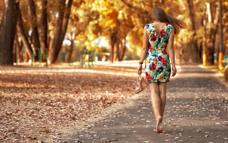 leaf, one Person, pavement, plant, trees, fun, lifestyles, day, joy, autumn, gray, sunlight, motion, long hair, dress, road, beauty, park - Man Made Space