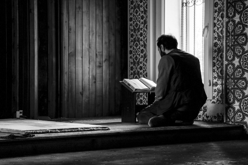 prayer, quran, lifestyles, sitting, real people, black and white, day, one person, book, adult, side view, allah, full length, 2K, muslim, sadness, islam