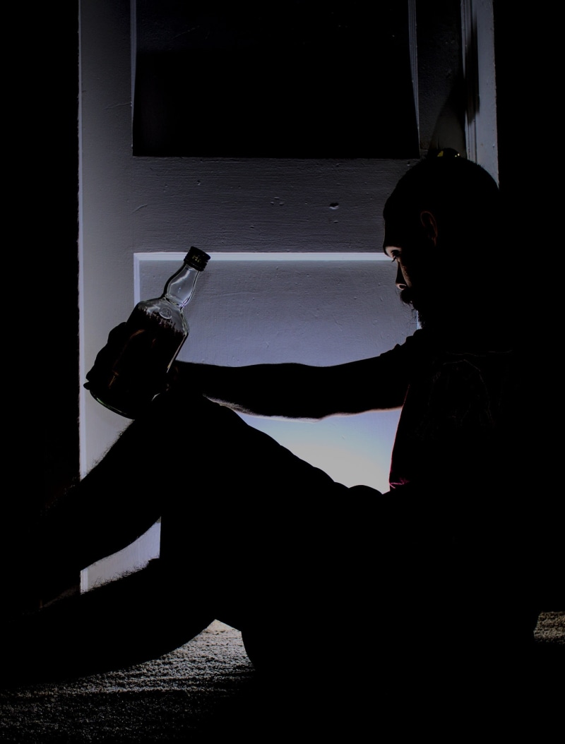 one woman only, lifestyles, 2K, depression, sunlight, sad, holding, dark, stress, bottle, architecture, one young woman only, sitting, sadness, person