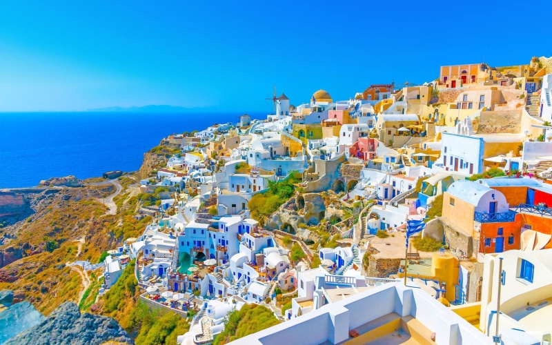 fira, sky, blue, travel destinations, residential district, outdoors, sunlight, land, capitals, island, building exterior, greece, largest, day, place