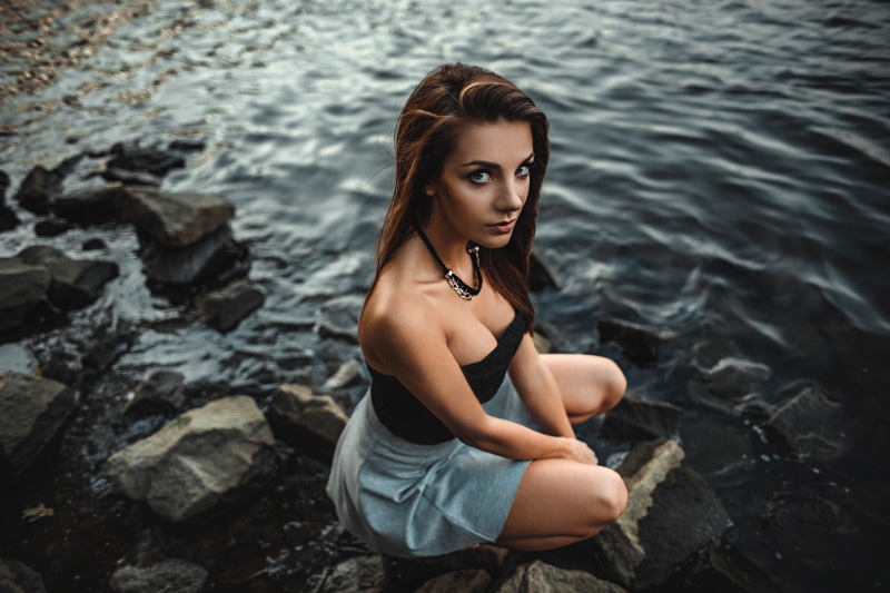 cleavage, hairstyle, tube, real people, adult, rock, women, skirt, one person, young adult, model, looking at viewer, lifestyles, looking at camera, long hair