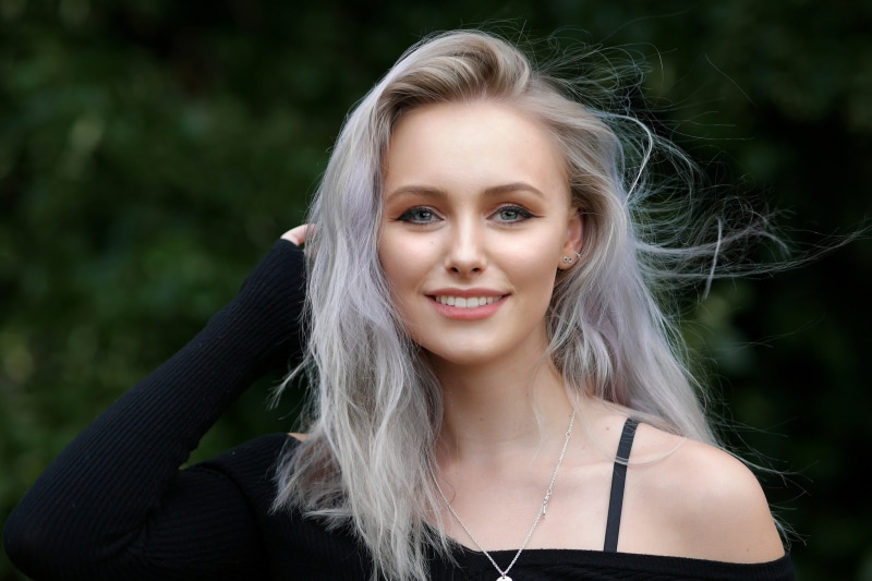 earring, depth of field, model, smiling, bare shoulders, portrait, silver hair, 1080P, gray eyes, women, touching hair, Abbie Charlotte, necklace, looking