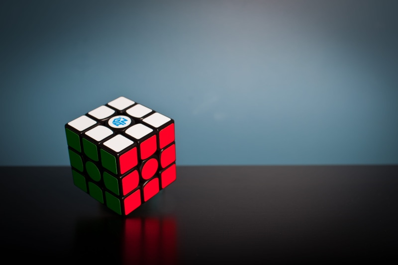 puzzle, single object, solution, indoors, design, cube, rubix cube, blue background, rubiks, toy, red, gray background, play, cube shape, solved, studio shot