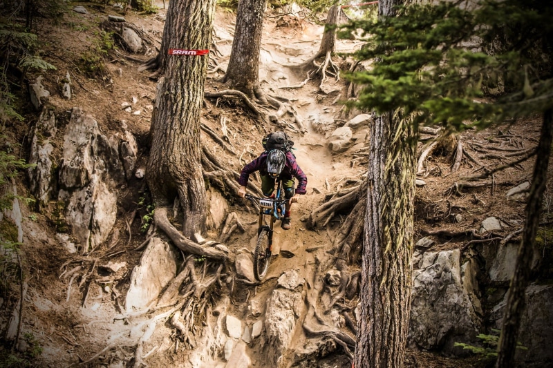 extreme sports, trees, rock, rock - object, plant, land, one person, rock formation, solid, activity, sport , bicycle, trunk, outdoors, tree trunk, real people