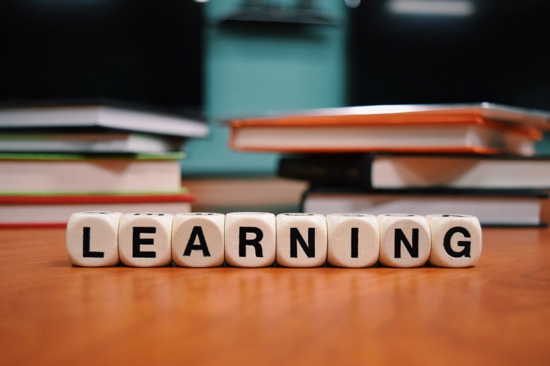 education, no people, surface, wood - material, brown, stack, text, group of objects, studying, Factory, focus on foreground, table, capital letter, communication