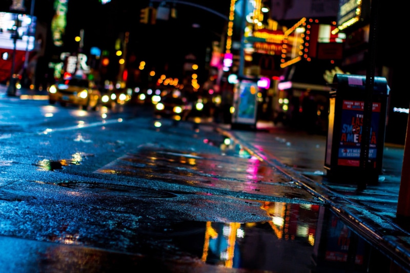 red, building Exterior, wet street, city street, black, communication, color Image, toy, city lights, mode of transportation, rain, built Structure, dark