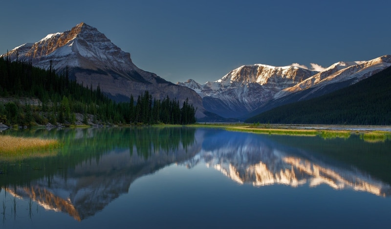 mountain range, reflection, landscape, sunlight, forest, cold temperature, mountain peak, morning, beauty in nature, winter, mountain, calm, scenics - nature