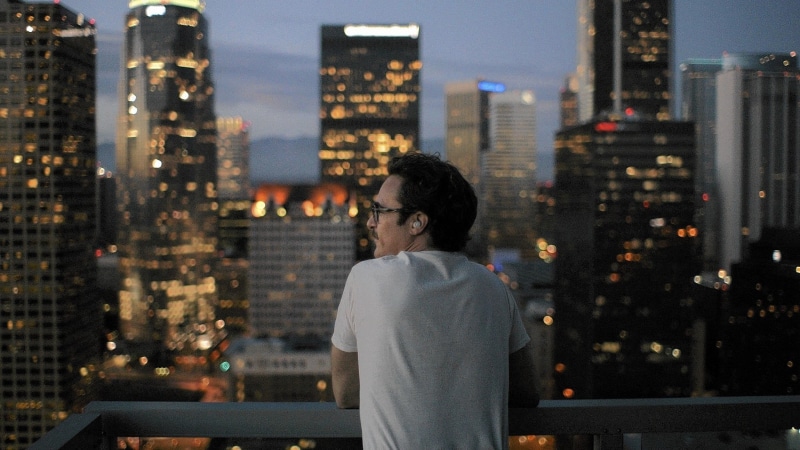 real people, standing, looking at view, Her (movie), city life, leisure activity, built structure, adult, cityscape, shirt, contemplation, office building exterior