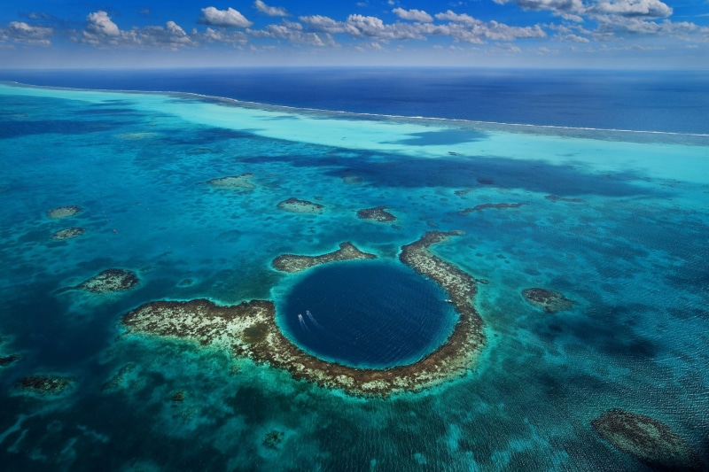 island, coral, sea, beach, beauty in nature, horizon over water, 720P, cloud - sky, scenics - nature, idyllic, sea life, land, marine, boat, Belize, no people