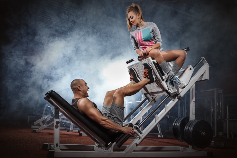 fitness, indoors, casual clothing, dumbbell, determination, smiling, wellbeing, training, gym, couple, leisure activity, beautiful, instructor, muscular Build
