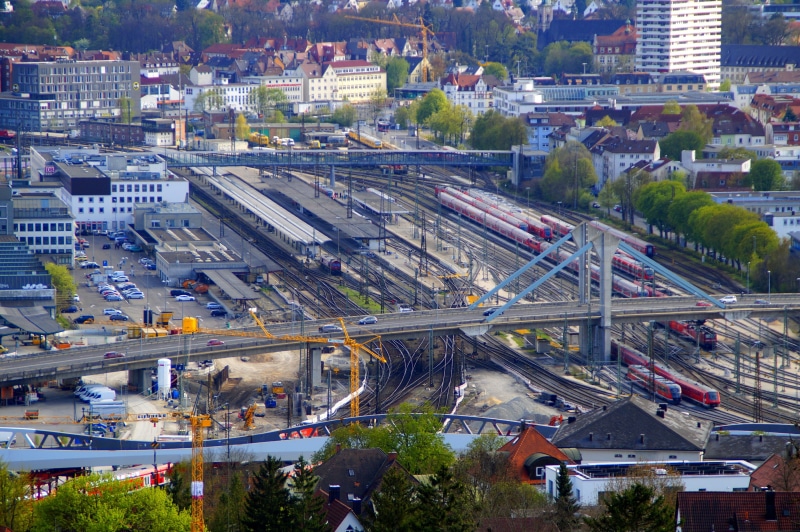 multiple lane highway, train - vehicle, central station, car, transport node, street, city life, outdoors, travel, no people, high angle view, trains, land vehicle