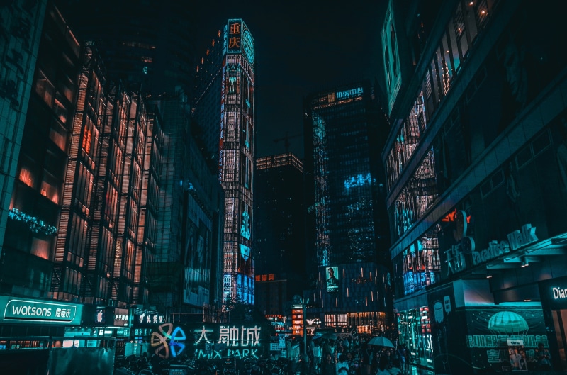 office building exterior, outdoors, architecture, tower, commercial sign, night, modern, advertisement, city, nightlife, cityscape, illuminated, communication
