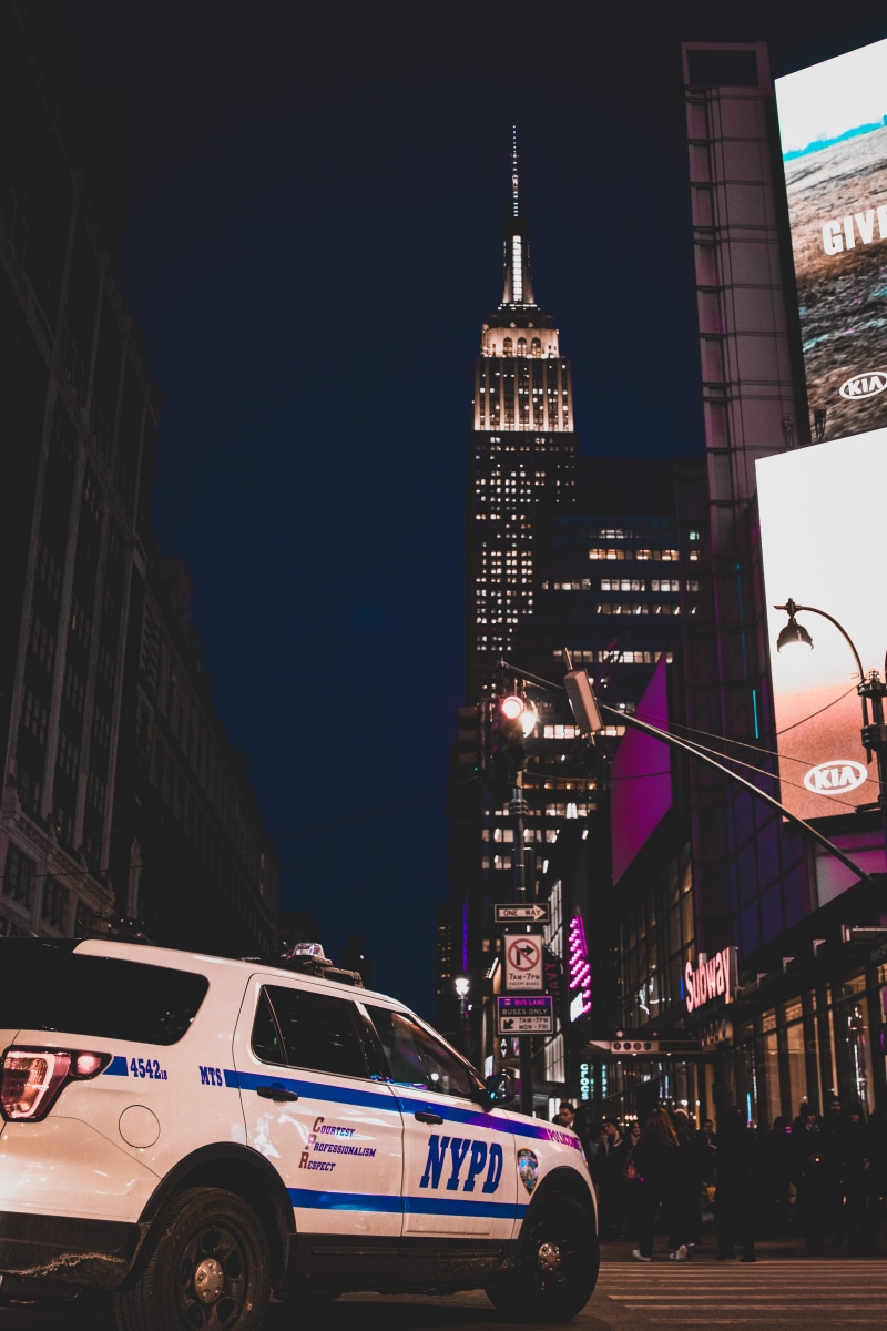 urban, city, mode of transportation, metropolis, vehicle, person, view, 5K, building exterior, united states, text, automobile, land vehicle, white, illuminated
