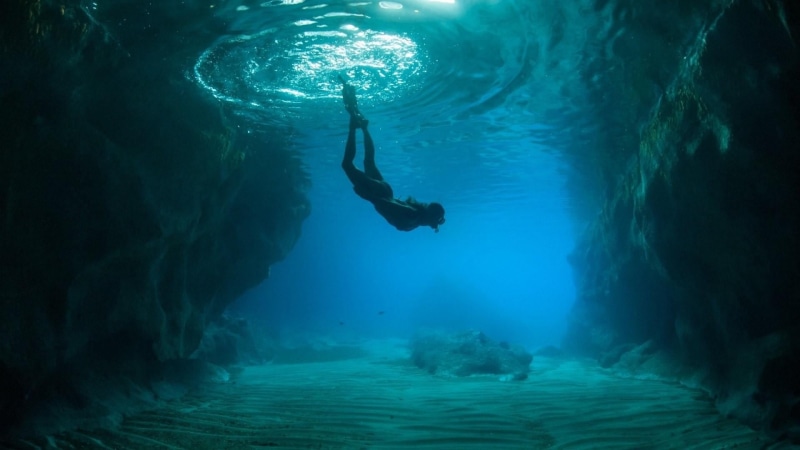 freediving, aquatic sport, beauty in nature, exploration, one person, underwater, sea cave, leisure activity, swimming, water, full length, real people
