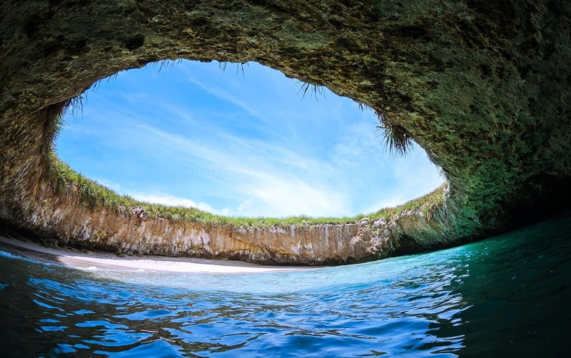 nature, flowing, flowing water, sky, beach, scenics - nature, tranquil scene, tranquility, sand, tree, sea, beauty in nature, island, blue, sunlight, cave