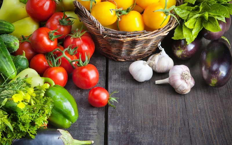 baskets, basket, wellbeing, container, indoors, large group of objects, wooden surface, green color, vegetable, still life, table, colorful, variety, eggplant