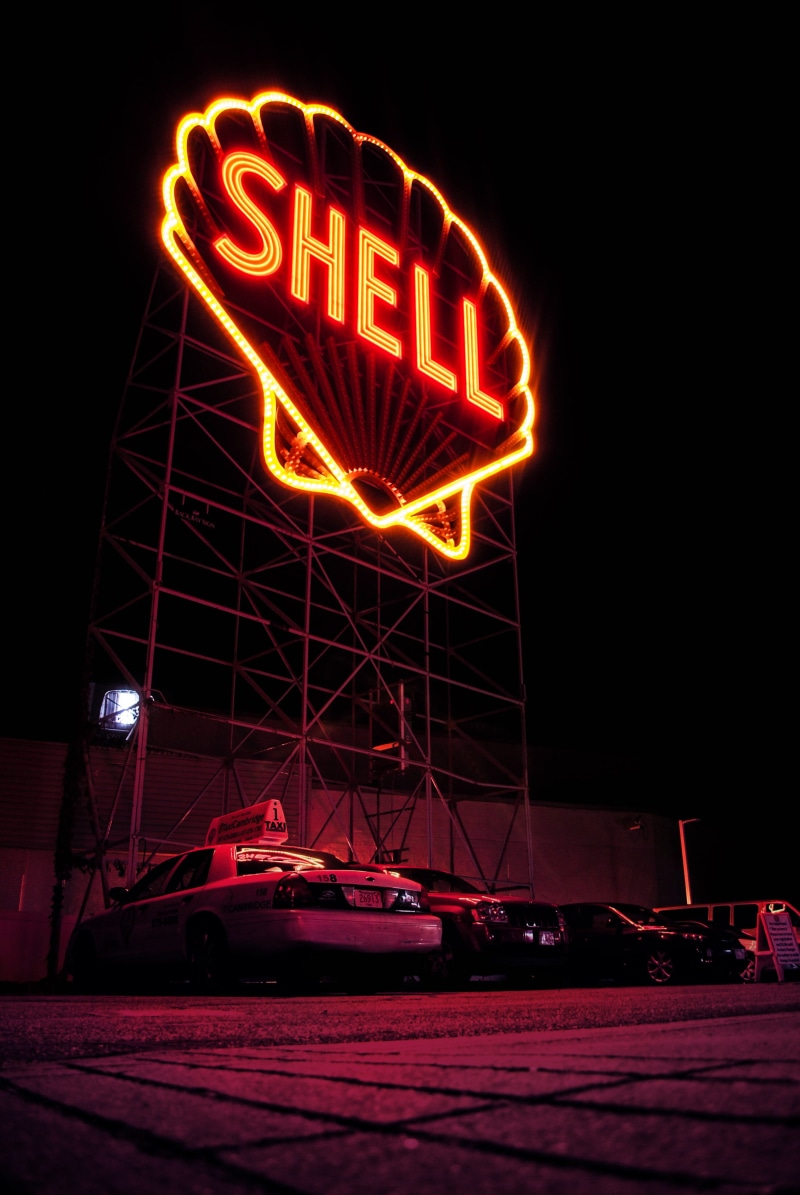 orange, signage, nature, sign, gas station, night, led, nightlife, graphic, scaffolding, mode of transportation, light, motor vehicle, design, logo, low angle view