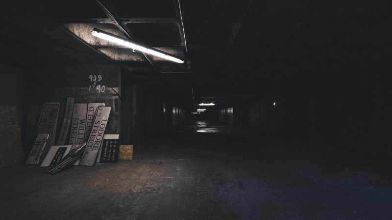 no people, illuminated, absence, indoors, night, transportation, copy space, spooky, music, architecture, dim, light, parking garage, seat, signboards