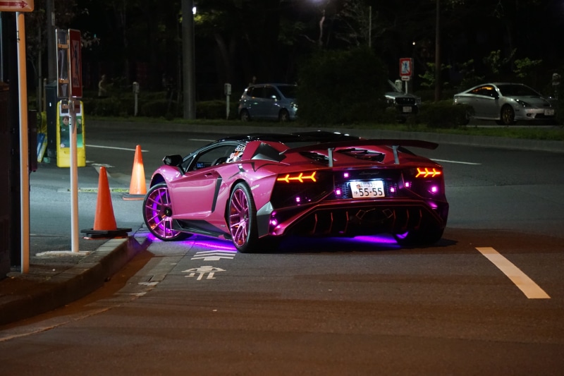 neon, motor vehicle, evening, mode of transportation, outdoors, night, tokyo, multi colored, street car, urban, car, pink, road, land vehicle, traffic