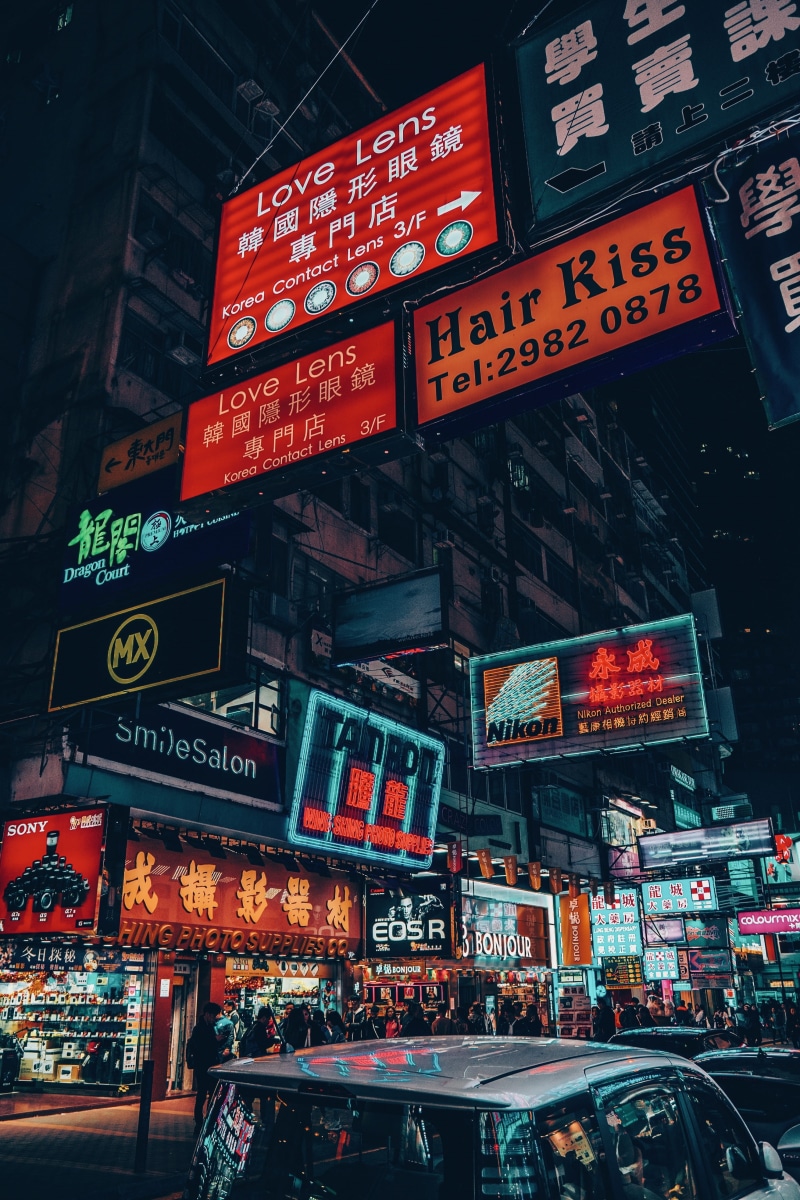 vehicle, commercial sign, non-western script, billboard, human, building exterior, information, 4K, cyperpunk, metropolis, town, text, downtown, script