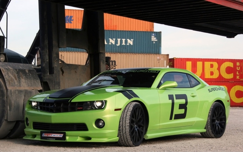 street, building exterior, motor vehicle, outdoors, green, text, garage, western script, built structure, black, Chevrolet Camaro, green color, stationary