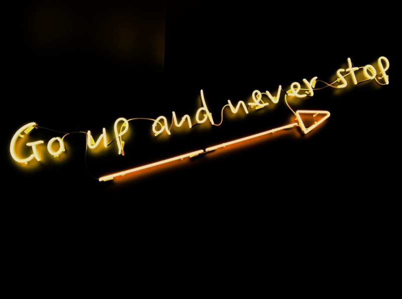 copy space, studio shot, Never Stop, black Color, nightlife, indoors, yellow, go, black background, neon Light, go up and never stop, arrow, illuminated